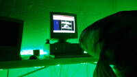 Some kind of fish looking at an image on the computer which reads ABOLISH THE FUCKING TWITTER